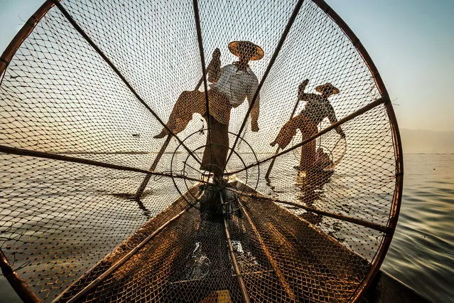“Intha fishermen”. The Ethnic Intha lives on the water of Inle Lake in Myanmar, and is composed primarily of skilled fishermen. They are famous for their original way of paddling, in fact, than the hands help with one leg, with which “wrap” the oar, slipping silently as snakes on water color inchistro of their lake. Photo location: Inle Lake, Myanmar. (Photo and caption by Michele Martinelli/National Geographic Photo Contest)