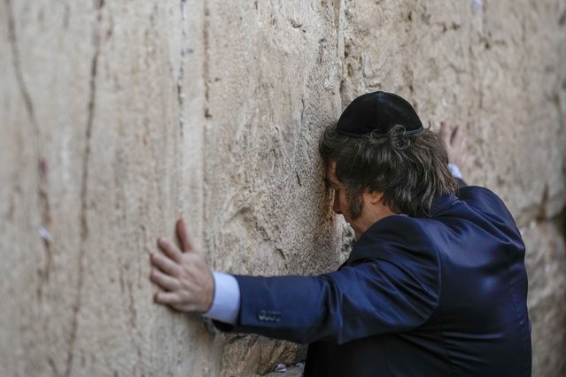 Argentine President Javier Milei touches the Western Wall, the holiest site where Jews can pray, in Jerusalem's Old City, Tuesday, February 6, 2024. (Photo by Leo Correa/AP Photo)