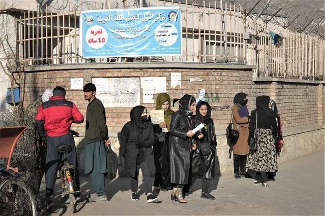 Afghan women students stand outside the Kabul University in Kabul, Afghanistan, on December 21, 2022. The United Nations' human rights chief on Tuesday Dec. 27, 2022 decried increasing restrictions on women's rights in Afghanistan, urging the country's Taliban rulers to reverse them immediately. He pointed to “terrible consequences” of a decision to bar women from working for non-governmental organizations. (Photo by Ebrahim Noroozi/AP Photo)