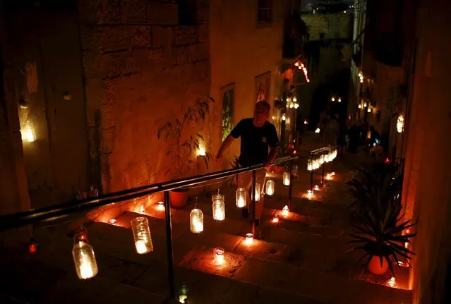 A visitor attends the activity "Birgu by Candlelight" in the medieval city of Birgu, also known as Vittoriosa, outside Valletta, Malta, October 10, 2015. (Photo by Darrin Zammit Lupi/Reuters)