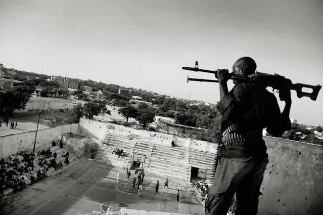 The 1st prize Sports – Sports Features Stories by Jan Grarup, Denmark, for Laif, shows the Somali basketball association pays armed guards to watch over and protect Suweys and her team when they play. In Mogadishu, the war-torn capital of Somalia, young women risk their lives to play basketball. Suweys, the 19-year-old captain of a women's basketball team, and her friends defy radical Islamist views on women's rights. They have received many death threats from not only al-Shabaab militias and radical Islamists, but some male members of their own families. “I just want to dunk”, said Suweys. It is on the basketball court she feels happiest. “Basketball makes me forget all my problems”. Mogadishu, Somalia, Feb. 21, 2012. (Photo by Jan Grarup/AP Photo/Laif)