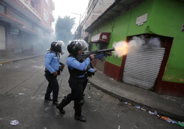 A police officer fires tear gas during clashes with demonstrators as Honduran President Juan Orlando Hernandez is sworn in for a new term in Tegucigalpa, Honduras, January 27, 2018. (Photo by Jorge Cabrera/Reuters)