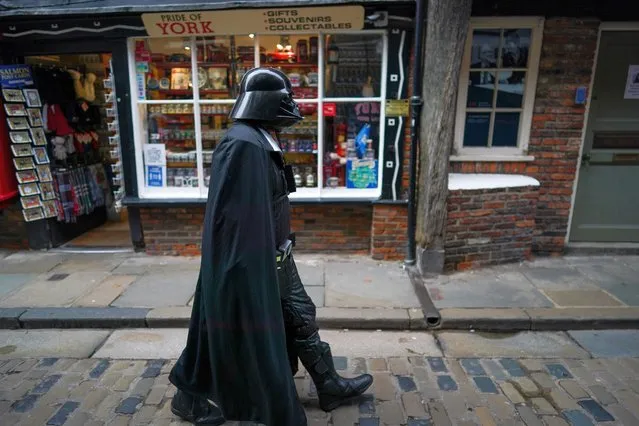 A man dressed as Darth Vader from Star Wars walks through York's famous Shambles street on October 18, 2020 in York, England. York city has become another of England’s high risk areas placed under “Tier 2” coronavirus lockdown measures as Government data indicates the R number range for the whole of the UK had increased slightly from between 1.2 and 1.5 last week to 1.3 and 1.5. Most notably the change will introduce a ban on people from different households from mixing anywhere indoors, prompting particular concern within the already badly-affected hospitality industry. (Photo by Ian Forsyth/Getty Images)