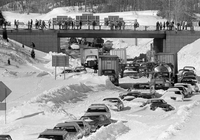 Cars and trucks stranded and abandoned in deep snow along Route 128 in Dedham, Mass., are seen in this February 9, 1978 photo, as military and civilian plows begin to dig them out during the blizzard of 1978. (Photo by AP Photo)