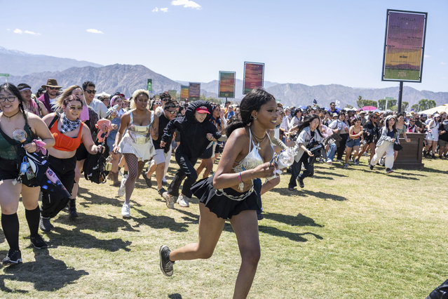 Festivalgoers are seen running to the gates during the the first weekend of the Coachella Valley Music and Arts Festival at the Empire Polo Club on Friday, April 12, 2024, in Indio, Calif. (Photo by Amy Harris/Invision/AP Photo)