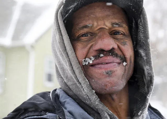 Erick Harrison shows the ice forming on his mustache as he shovels a sidewalk during a winter storm on Wednesday, February 22, 2023, in Sioux Falls, S.D. Brutal winter weather is hammering the northern U.S. with “whiteout” snow, dangerous wind gusts and bitter cold. (Photo by Erin Woodiel/The Argus Leader via AP Photo)