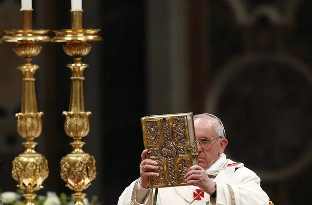 Pope Francis holds the Book of the Gospels as he leads a vigil mass during Easter celebrations at St. Peter's Basilica in the Vatican March 30, 2013. (Photo by Stefano Rellandini/Reuters)