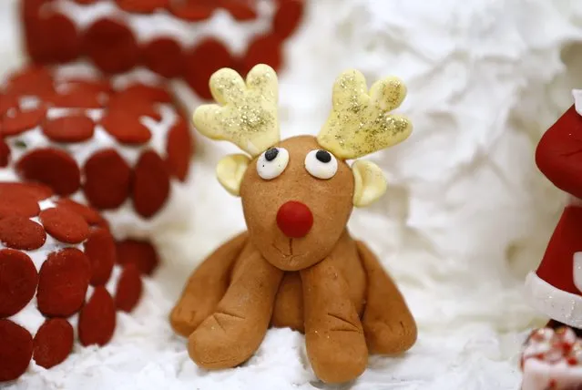 A fairy tale and movie-themed gingerbread house creation, featuring a reindeer, made by pastry students of the San Ysidro Adult School Culinary Arts program is pictured during their 9th annual gingerbread house competition in San Ysidro, California December 9, 2014. (Photo by Mike Blake/Reuters)