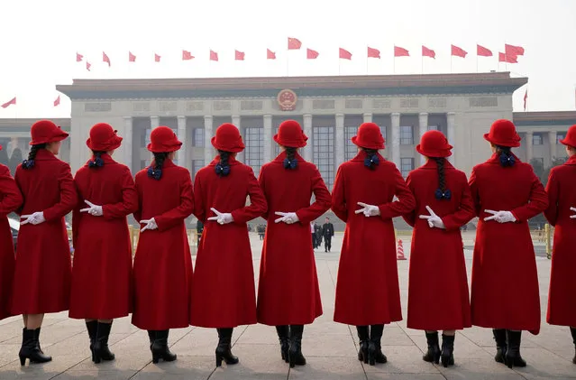 Hotel ushers pose for a photo at Tiananmen Square as delegates attend the second plenary session of the National People's Congress (NPC) in Beijing, China, March 9, 2018. (Photo by Jason Lee/Reuters)