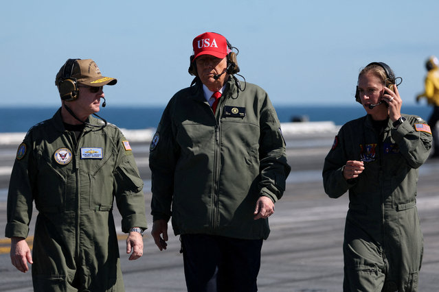 U.S. President Donald Trump walks flanked by U.S. Navy sailors aboard the aircraft carrier USS George H.W. Bush off the coast of Norfolk, Virginia, U.S. October 5, 2025. (Photo by Jonathan Ernst/Reuters)