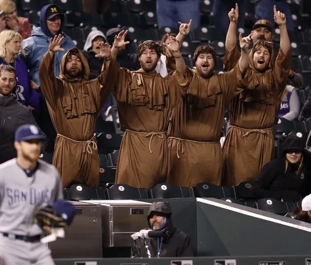 Fans dressed as friars cheer for members of the San Diego Padres as they take the field in the bottom of the seventh inning of a baseball game against the Colorado Rockies, Monday, April 23, 2018, in Denver. The Padres won 13-5. (Photo by David Zalubowski/AP Photo)