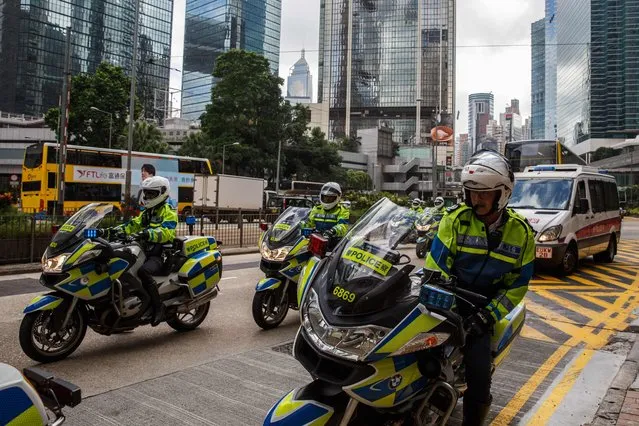 Police arrive as a convoy to transport a van (not seen) used to transport British banker Rurik Jutting, 31, accused of the murders of two Indonesian women, arrives at the High Court in Hong Kong on October 24, 2016, on the first day of what is Hong Kong's biggest murder case for years. Jutting pleaded 'not guilty' to two charges of murder on October 24 as he stood trial for the killings of two Indonesian women who were found in his upscale Hong Kong apartment. (Photo by Anthony Wallace/AFP Photo)