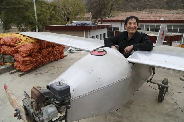 Chen Lianxue, 50-year-old farmer, sits in his homemade plane to pose for a photograph on the roof of his house in Qifu village of Pingliang, Gansu province, China, November 22, 2015. (Photo by Reuters/China Daily)