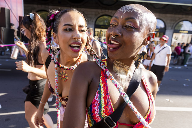 Ravers dance around Love Mobiles during the 22nd edition of the Lake Parade in Geneva, Switzerland, 20 July 2024. (Photo by Salvatore Di Nolfi/EPA/EFE)