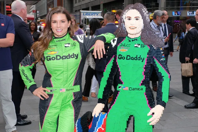 Professional racing driver Danica Patrick poses for photos with a life-sized Lego statue of herself at NASDAQ MarketSite on May 22, 2018 in New York City. (Photo by Matthew Eisman/Getty Images)