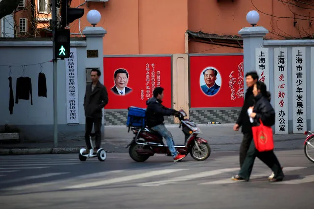 People cross a street beside posters depicting late Chairman Mao Zedong (R) and China's President Xi Jinping in Shanghai, China March 1, 2016. (Photo by Aly Song/Reuters)