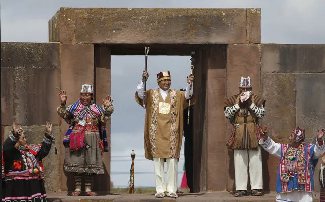 Bolivia's president Evo Morales holds his scared staffs of power during a blessing by Aymaran spiritual guides, in a traditional ceremony at the archeological site Tiwanaku, Bolivia, Wednesday, January 21, 2015. Morales is set to begin a new term Thursday, that will make him the Andean nation's longest-serving leader, riding high on a wave of unprecedented growth and stability. (Photo by Juan Karita/AP Photo)