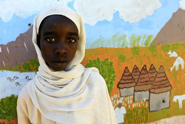 Mozdalifa Abaker Omer, a 5th grader at the Alsalam 2 School for Girls at Aboshok camps for the internally displaced persons poses for a photograph in El-Fasher, North Darfur, Sudan, November 17, 2015. Born in the camp, 12 years old Omer wishes to be a doctor in her adulthood. (Photo by Mohamed Nureldin Abdallah/Reuters)