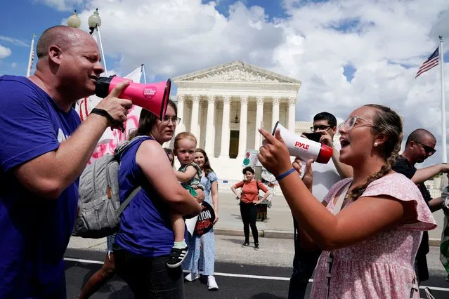 Abortion rights activists and counter protesters protest outside the U.S. Supreme Court on the first anniversary of the court ruling in the Dobbs v Women's Health Organization case, overturning the landmark Roe v Wade abortion decision, in Washington, U.S., June 24, 2023. (Photo by Elizabeth Frantz/Reuters)