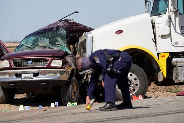 The scene of a collision between a sport utility vehicle (SUV) and a tractor-trailer truck is seen near Holtville, California, U.S., March 2, 2021. At least 13 people, 10 of them Mexican nationals, were killed on Tuesday when a tractor-trailer slammed into an SUV crammed with 25 adults and children on a dusty Southern Californian road near the U.S.-Mexico border, officials said. (Photo by Bing Guan/Reuters)
