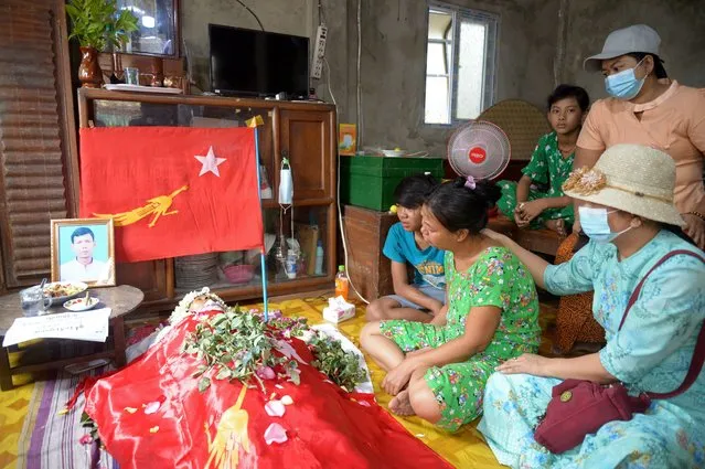 Relatives view the remains of Aung Aung Zaw at the family home in Yangon, Myanmar Saturday, March 13, 2021. Aung Aung Zaw is a 41-year old supporter of the National League for Democracy party who was shot after midnight Saturday while he was among a group of people outside a police station in Thar Kay Ta township in Yangon demanding that they release people who were arrested. Police in Myanmar fired rubber bullets and tear gas at protesters in the country's two largest cities and elsewhere on Friday, as authorities continued their harsh crackdown on opponents of last month's military coup. (Photo by AP Photo/Stringer)