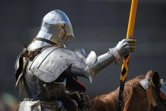 A rider dressed as a knight takes part in the International Jousting Tournament, held at the Royal Armouries Museum in Leeds, northern England on April 18, 2022. The four-day tournament, running from April 15 to 18, 2022, has seen knights from Norway, Portugal and the UK battle to be awarded the museum's Sword of Honour and Queen's Jubilee Trophy. The competition is the first time the Royal Armouries Museum has staged a tournament since the Covid-19 pandemic. Points are awarded for: horsemanship, lance skills as well as the accuracy and striking power in the joust. (Photo by Oli Scarff/AFP Photo)