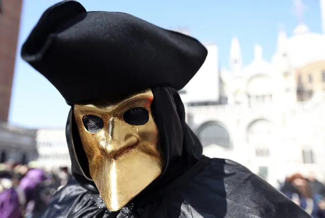 A masked reveller poses in front of Saint Mark's square during Carnival in Venice, February 8, 2015. (Photo by Stefano Rellandini/Reuters)