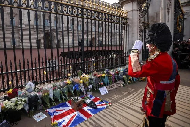 A man gestures in front of Buckingham Palace after Britain's Prince Philip, husband of Queen Elizabeth, died at the age of 99, in London, Britain, April 9, 2021. (Photo by Henry Nicholls/Reuters)