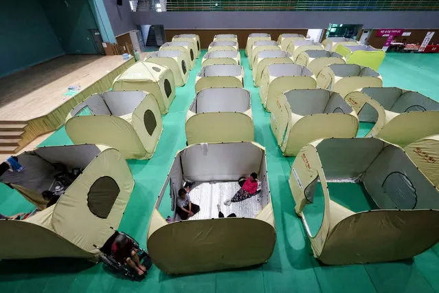 Victims of the torrential rains sit inside their tent at a temporary shelter at the Culture and Sports Center in Yecheon-gun, Gyeongsangbuk-do province, South Korea, 17 July 2023. According to the National Fire Agency (NFA), at least 40 people are dead and nine missing nationwide due to flooding and landslides following heavy rains. The country's central and southern regions are bracing for another spell of torrential rains, the state weather agency said on 17 July. (Photo by Jeon Heon-Kyun/EPA/EFE)