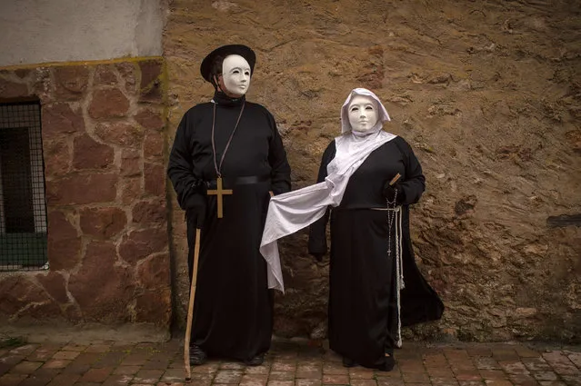 People dressed up as a cure and nun pose for a picture as they join a carnival festival on February 14, 2015 in Luzon, Spain. (Photo by David Ramos/Getty Images)