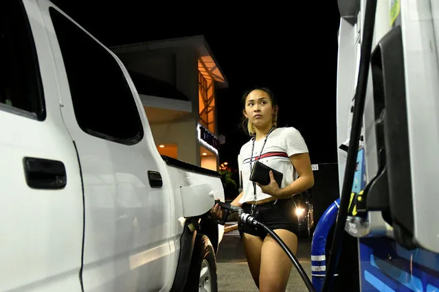 Jaycee Sotello fills her truck up with gas as Hurricane Lane approaches Honolulu, Hawaii, U.S. August 21, 2018. (Photo by Hugh Gentry/Reuters)