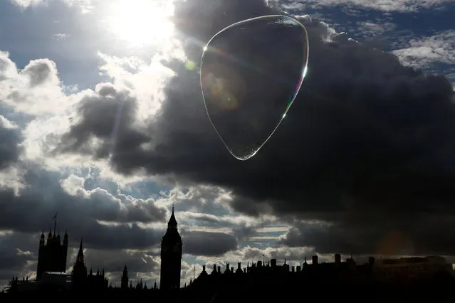 A giant soap bubble floats past the Houses of Parliament in central London, Britain October 10, 2016. (Photo by Stefan Wermuth/Reuters)
