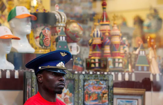 A man wearing a Soviet Air Force officer's cap stands in front of a tourist shop in central Moscow, Russia on September 18, 2018. (Photo by Maxim Shemetov/Reuters)