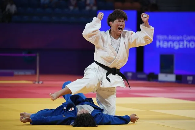 China's Ma Zhenzhao in white reacts as she fights Japan's Takayama Rika in the women's -78kg gold medal match at the 19th Asian Games in Hangzhou, China, Tuesday, September 26, 2023. (Photo by Vincent Thian/AP Photo)