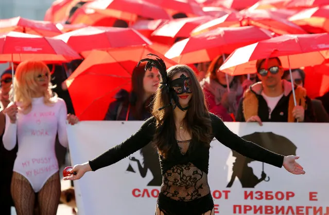 s*x workers carrying red umbrellas participate in a march to raise public awareness on human rights issues in their profession on International Day to End Violence Against s*x Workers in Skopje, Macedonia December 17, 2016. (Photo by Ognen Teofilovski/Reuters)