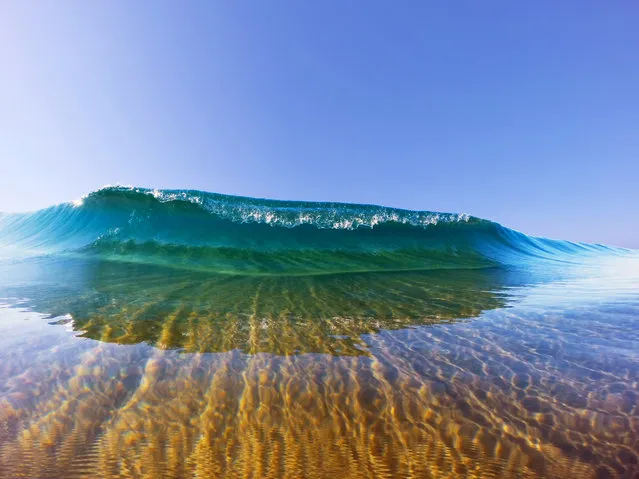 Feeling cleansed: a gentle wave seen in shallow water on July, 18, 2015, in Durban, South Africa. (Photo by Marck Botha/Barcroft Media)