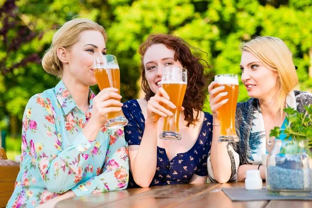 Friends toasting with beer in garden pub. (Photo by Alamy Stock Photo)