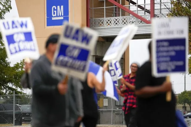 Picketers strike outside of the General Motors assembly plant, Tuesday, October 24, 2023, in Arlington, Texas. The United Auto Workers union is turning up the heat on General Motors as 5,000 workers walked off their jobs at a highly profitable SUV factory. (Photo by Julio Cortez/AP Photo)