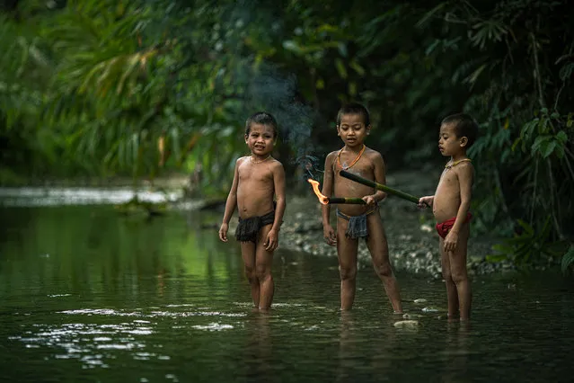 Young children play in the local river taken on July 19, 2014 on the Mentawai Islands, Indonesia. (Photo by Muhamad Saleh Dollah/Barcroft Media)