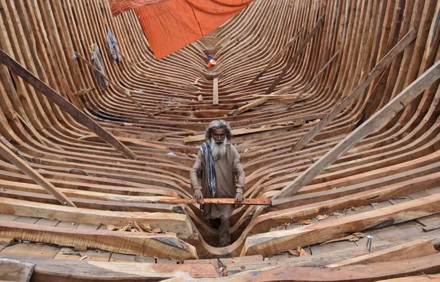A Pakistani carpenter works on a fishing boat at the harbor of Karachi, Pakistan, Monday, June 25, 2012. (Photo by Shakil Adil/AP Photo)