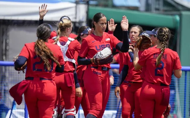 United States' Cat Osterman celebrates with teammates during the softball game between Italy and the United States at the 2020 Summer Olympics, Wednesday, July 21, 2021, in Fukushima , Japan. (Photo by Jae C. Hong/AP Photo)