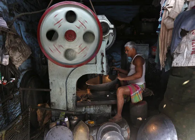 A worker operates a lathe as he makes iron plates at an iron utensils manufacturing unit in Kolkata, India, February 1, 2016. Indian manufacturing activity unexpectedly returned to growth in January as firms raised output on stronger demand, a survey showed, adding to expectations the central bank will likely leave policy unchanged this month. (Photo by Rupak De Chowdhuri/Reuters)