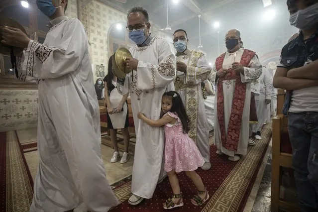 Coptic Orthodox deacon pray during Easter mass, at Holy Cross Church in Cairo, Egypt, Saturday, May 1, 2021. Orthodox Christians around the world celebrate Easter on Sunday, May 2. (Photo by Nariman El-Mofty/AP Photo)