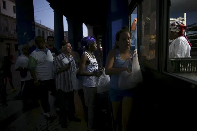 People line up to buy bread at a subsidised state store, or “bodega”, where Cubans can buy basic products with a ration book they receive annually from the government, in downtown Havana December 29, 2015. (Photo by Alexandre Meneghini/Reuters)