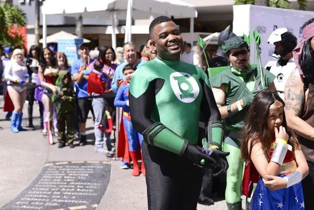 Fans dressed as DC Comics Super Heroes gather to celebrate with interactive games and activities inspired by the famed world of DC Comics at the DC Comics Super Hero World Record Event to set a Guinness World Record at the Hollywood & Highland Center on Saturday, April 18, 2015, in Los Angeles. (Photo by Dan Steinberg/Invision for Warner Bros. Consumer Products/AP Images)
