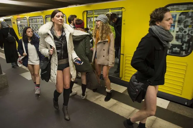 People taking part in the “No Pants Subway Ride” exit a train on the U2 Subway line in Berlin on January 12, 2014. (Photo by Odd Andersen/AFP Photo)