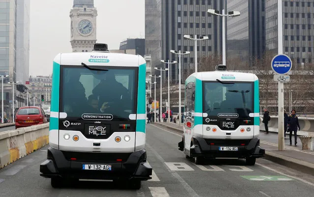 Two self-driving electric minibuses are seen on the 130-metre (142-yard) test route between Gare de Lyon and Austerlitz train stations, the first regular line opened by the Paris transport company RATP, in Paris, France, January 24, 2017. (Photo by Jacky Naegelen/Reuters)