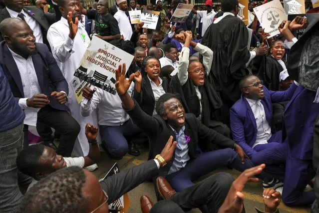 Kenyan advocates gesture during a picket following a protest call to members by the Law Society of Kenya against recent remarks by Kenya's President, William Ruto, accusing the judiciary of wide spread corruption and lacking in integrity, in the Central Business District in Nairobi on January 12, 2024. Ruto triggered uproar after accusing some judicial officials of working corruptly with his opponents to try to derail some key government policies. (Photo by Tony Karumba/AFP Photo)