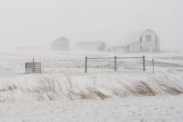 An American flag is seen fixed to a farm fence along US Highway 20 during a blizzard near Galva, Iowa, Saturday, January 13, 2024. (Photo by Carolyn Kaster/AP Photo)