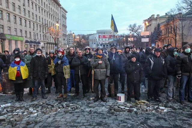 Pro-European integration protesters sing an anthem during a rally near government administration buildings in Kiev, on January 20, 2014. (Photo by Valentyn Ogirenko/Reuters)